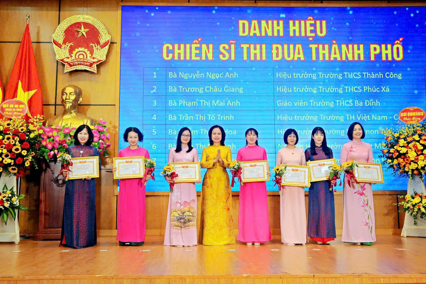A group of women holding certificates
Description automatically generated