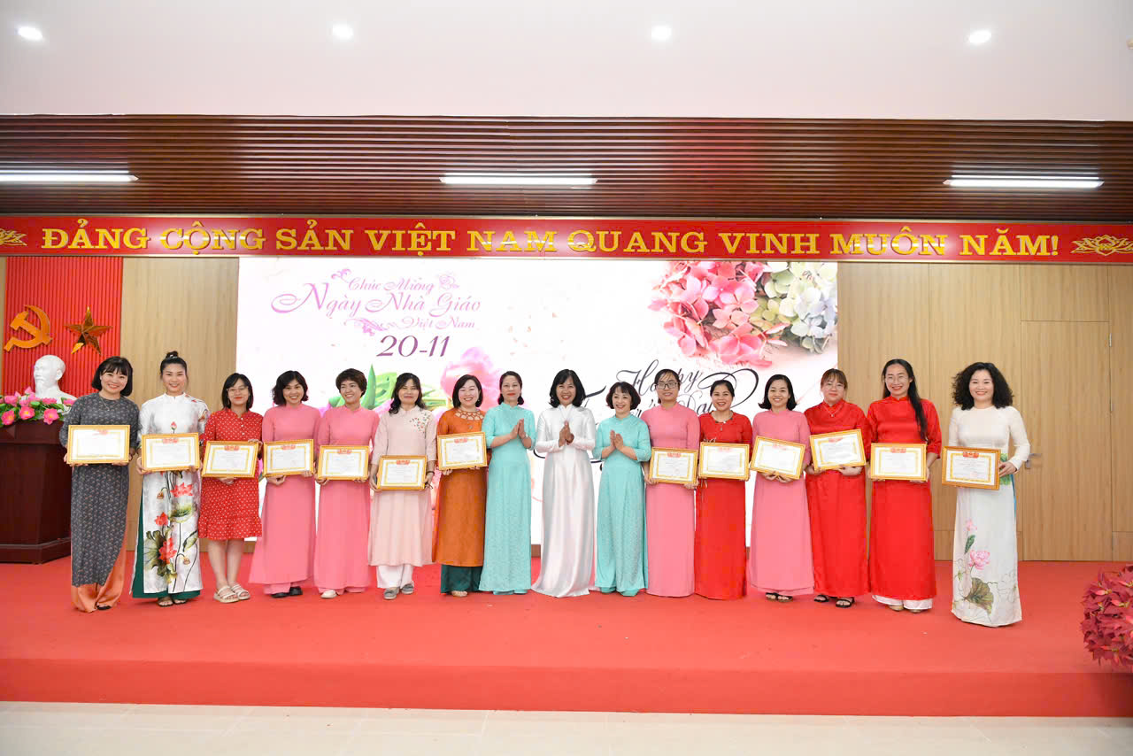 A group of women holding certificates
Description automatically generated