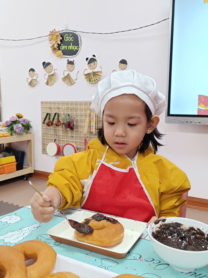 A child in a kitchen eating food

Description automatically generated