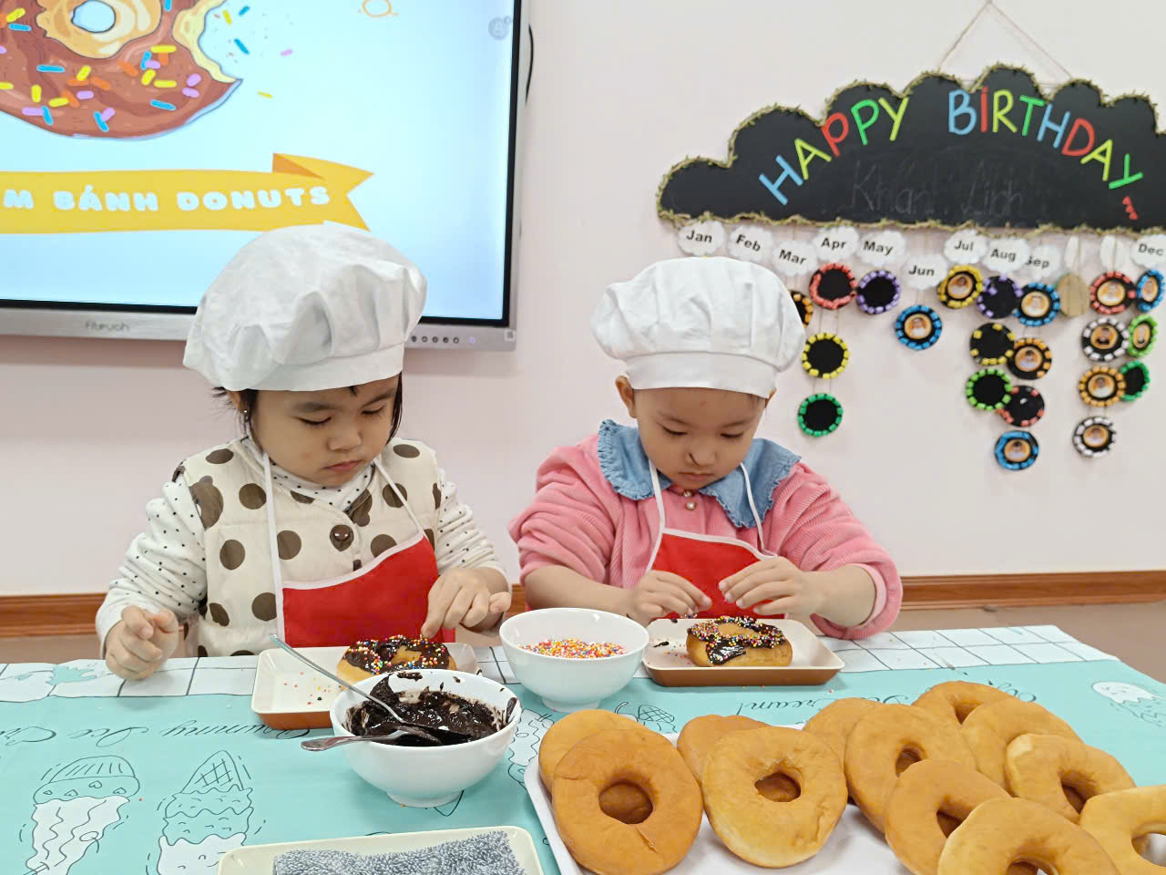 Two children wearing chef hats and cooking
Description automatically generated