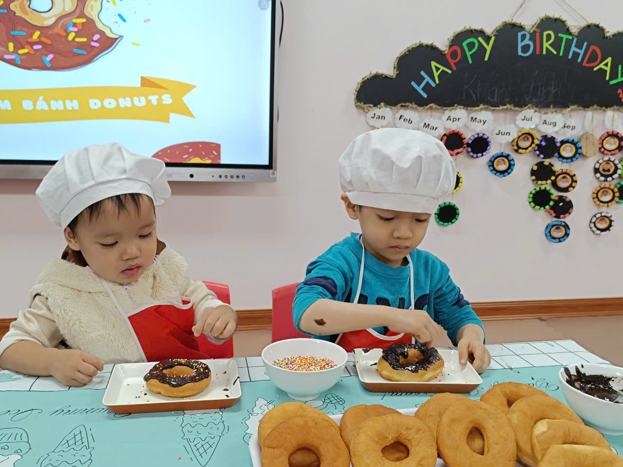 Two children eating donuts
Description automatically generated