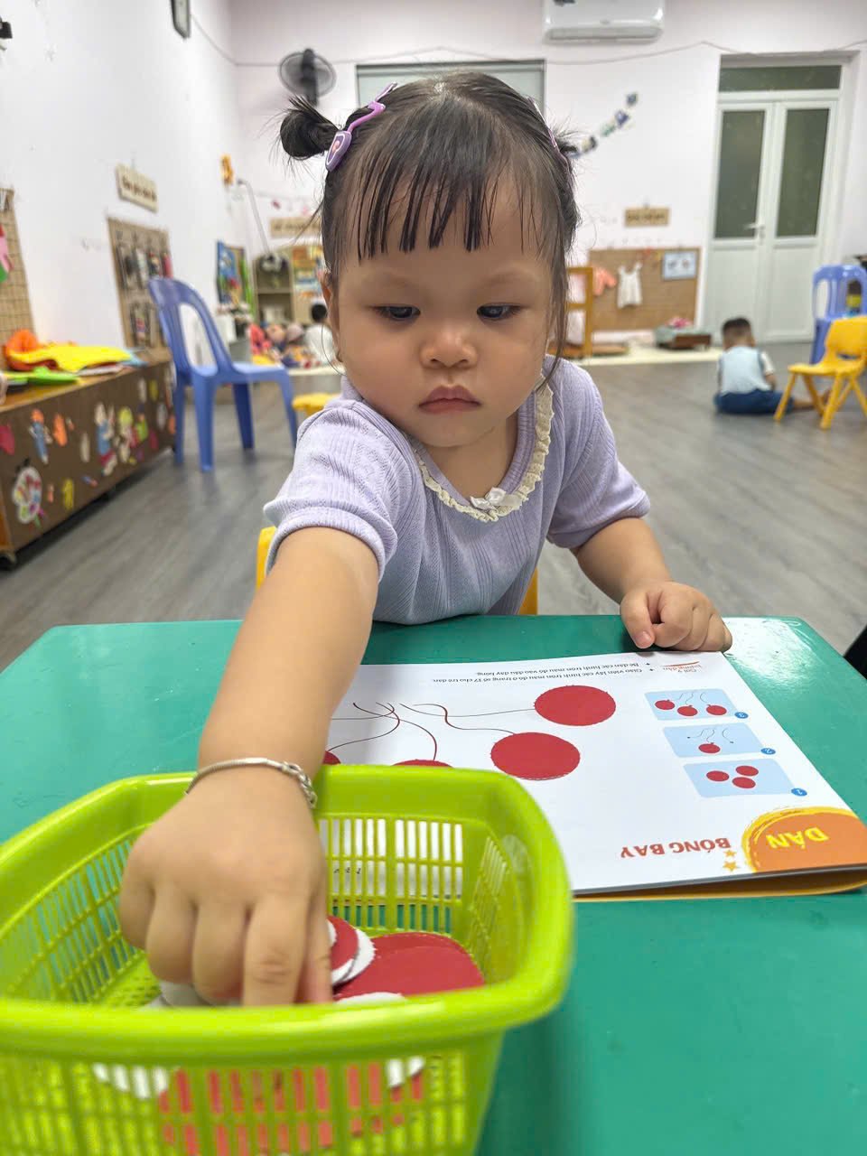 A child playing with a basket
AI-generated content may be incorrect.