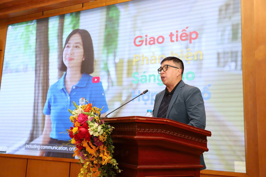 A person standing at a podium with a microphone and flowers
AI-generated content may be incorrect.